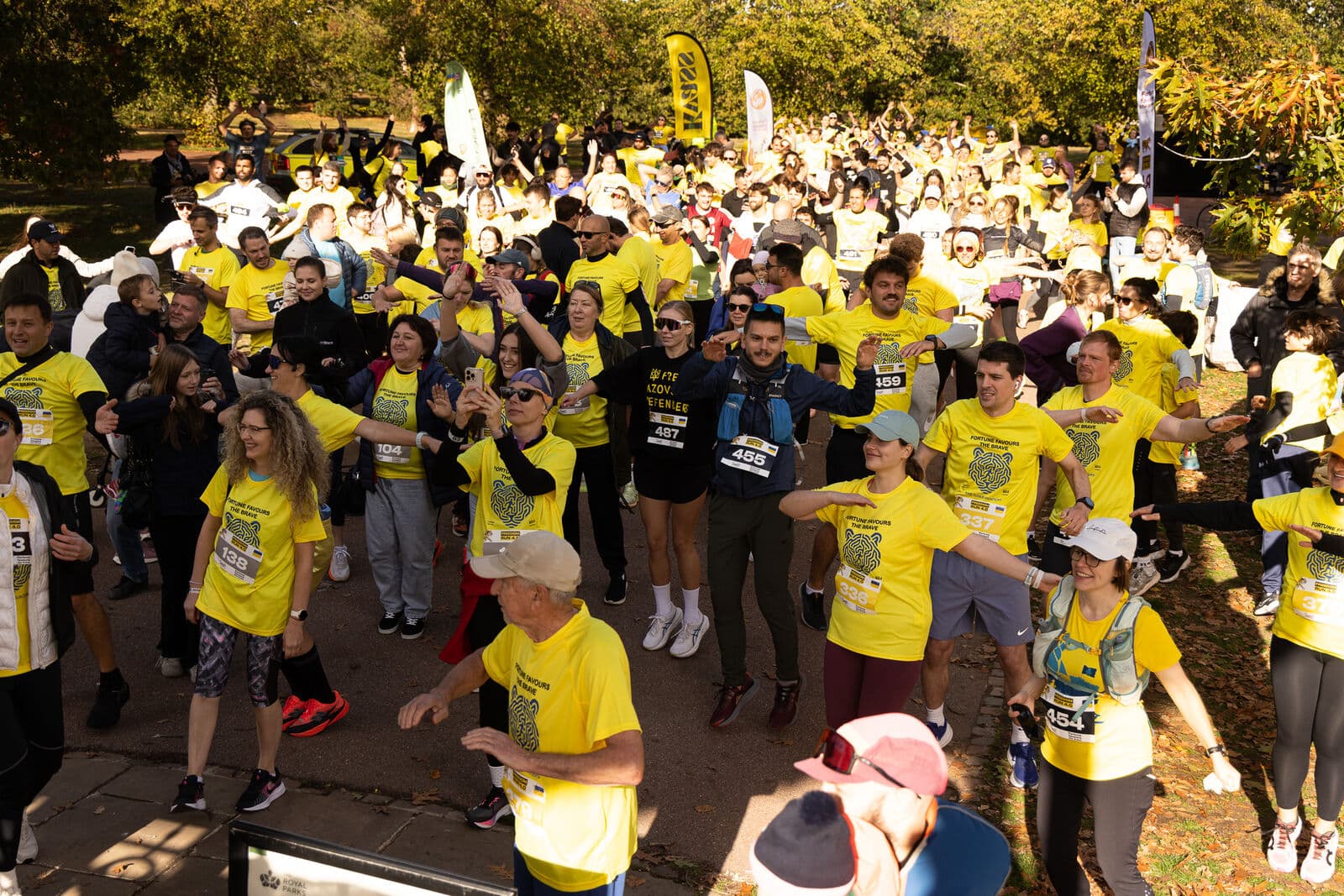 Runners in yellow Freedom Run T-shirts warming up together before the start
