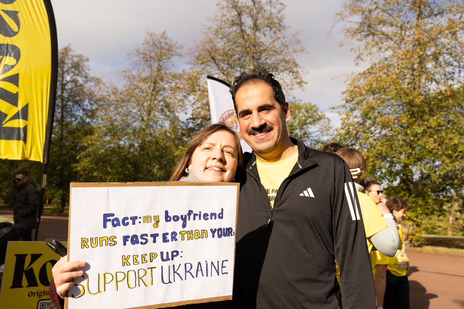 Supporters holding a sign reading "Support Ukraine"