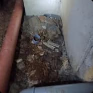 An unrenovated basement floor and walls